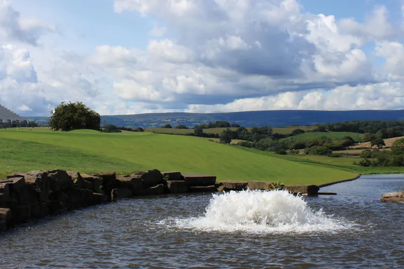 Otterbine High Volume floating aerator pumping water on a pond